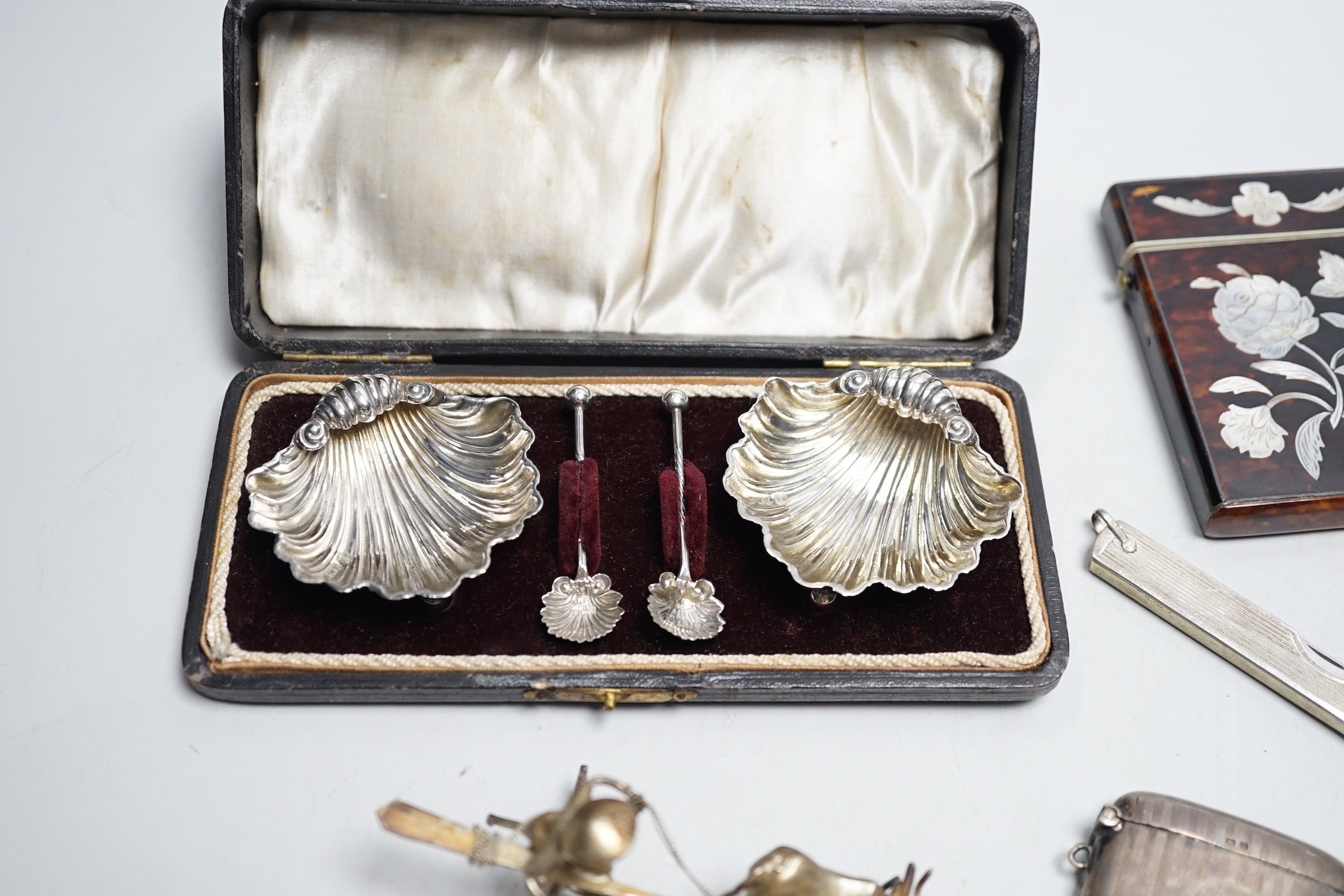 A cased pair of Edwardian silver shell salts, with spoons, and other items including Edwardian silver mounted bird pin cushion, by Sampson Mordan & Co, vesta cases, inlaid tortoiseshell card case etc.